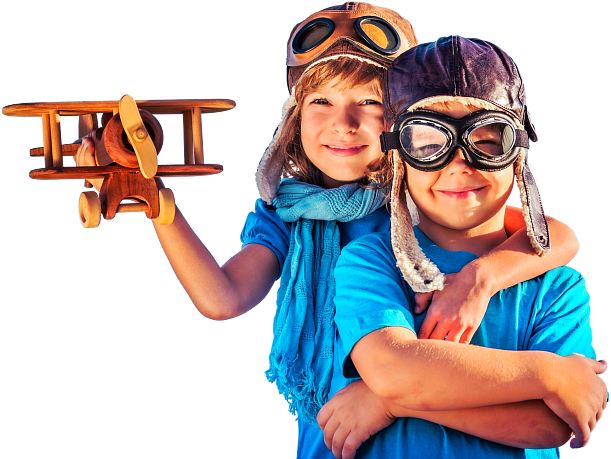 boy and girl standing wearing pilot head gear while girl holding plane